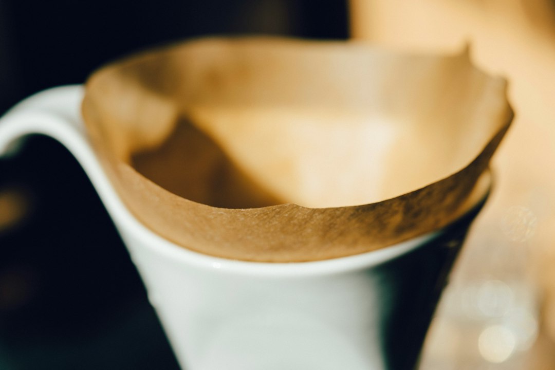 Coffee being brewed by hand in a pour-over dripper