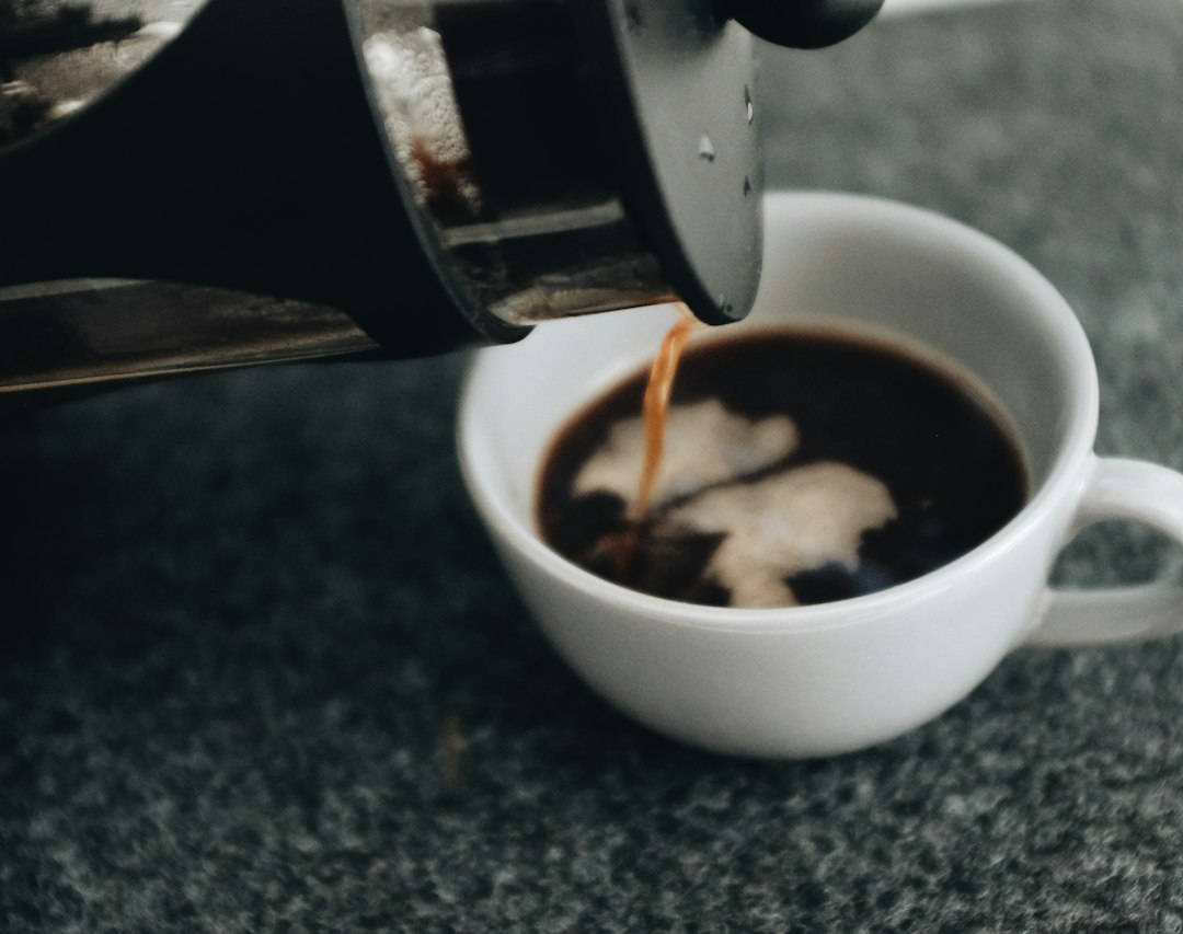 Freshly brewed coffee being poured into a cup
