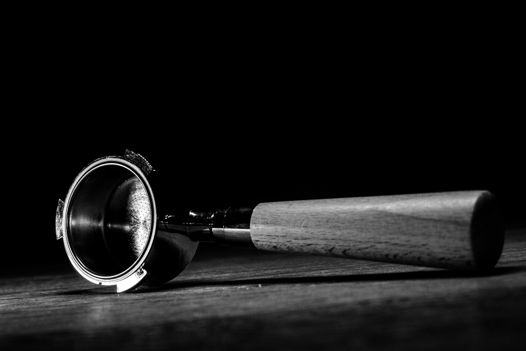 Portafilter with a wooden handle on a wooden surface