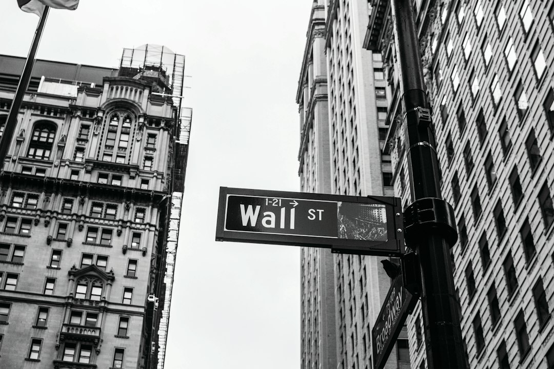 Black and white photo of a Wall Street sign in New York