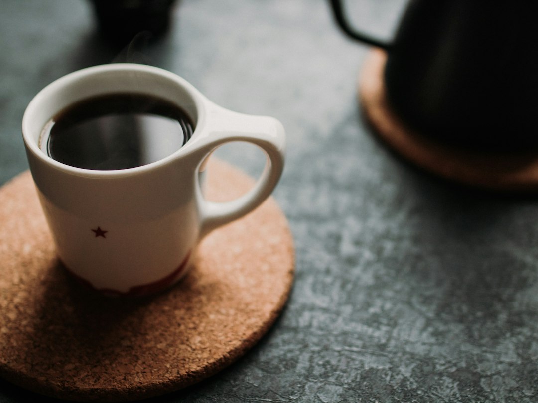 White cup of coffee in focus