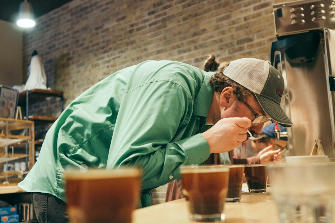 Man tasting a drink from a cup