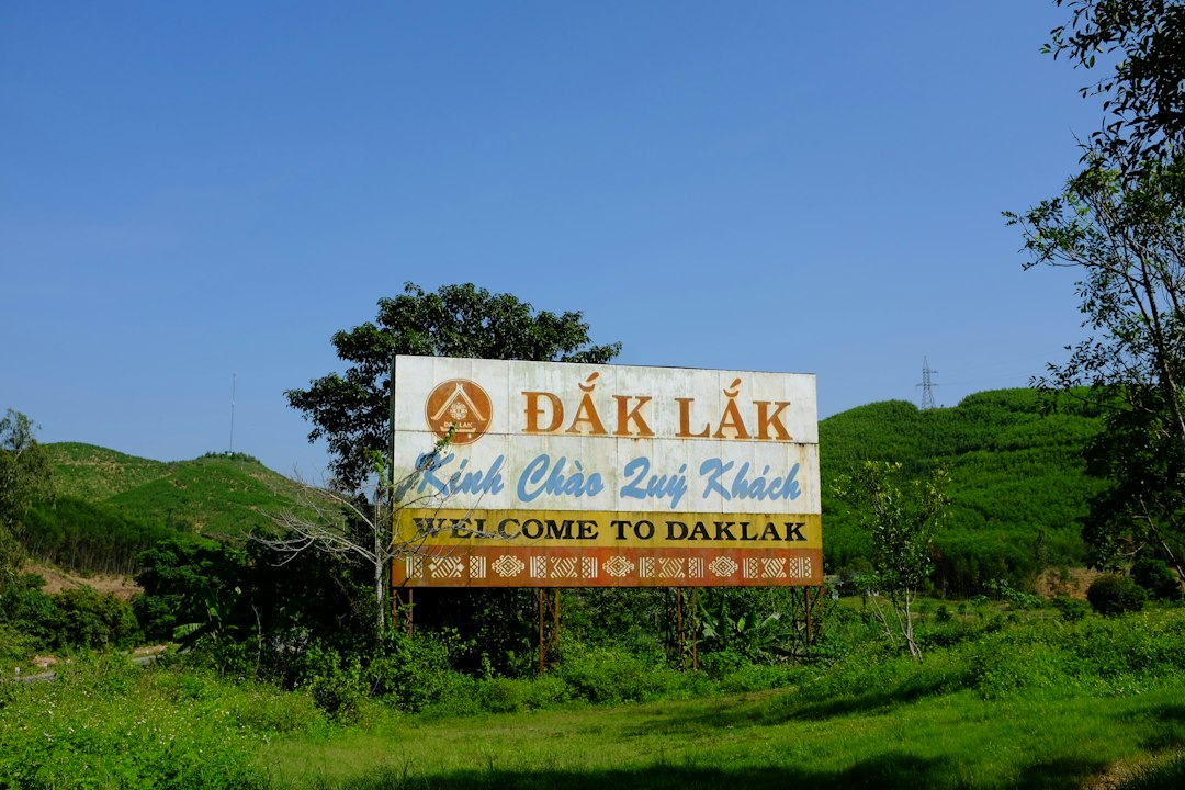 ‘Welcome to Daklak’ sign between green hills in Vietnam